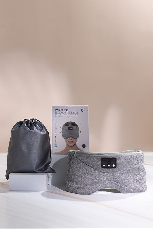 A weighted sleep eye mask with built-in and bluetooth audio, beside its grey drawstring pouch.